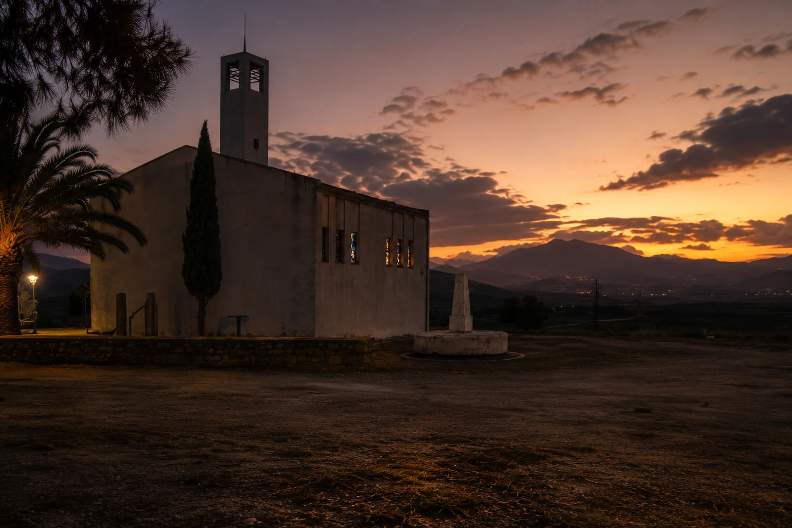Andalusian chapel and mountain landscape at sunset